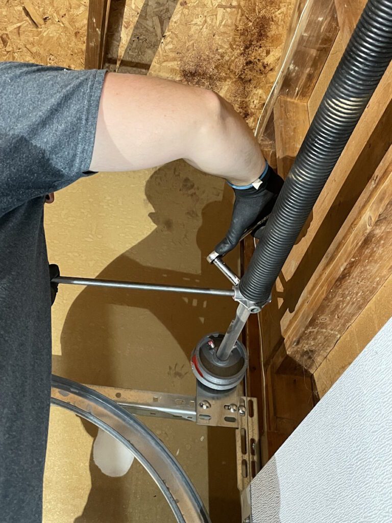 Penguin Garage Doors technician installing a new garage door spring for safe and reliable operation in Newmarket.